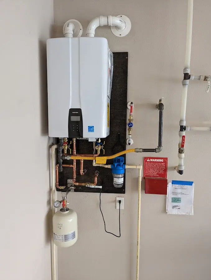 Professional plumber installing copper piping in a Brandywine home